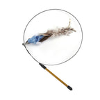 Close-up of the replaceable blue-brown feather teaser attachment on the Aevvon cat wand toy